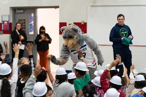 Display image of the Minnesota Timberwolves mascot celebrating National Reading Month
